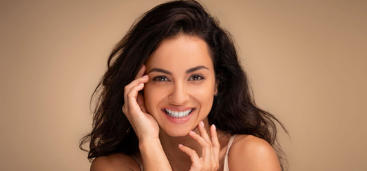 cheerful beatiful woman with perfect skin touchig her face