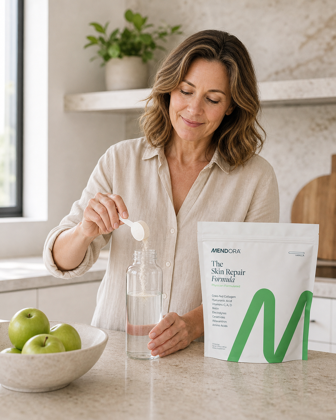 Woman preparing Mendora Skin Repair Formula in her kitchen.
